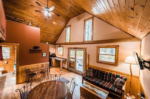 Living room, dining room, kitchen of cabin rental at Northern Outdoors.